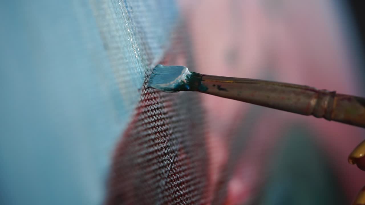 Close up of an artist painting on canvas