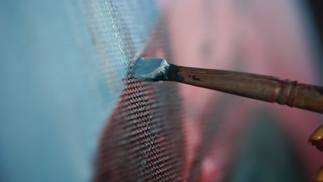 close up of an artist painting on canvas