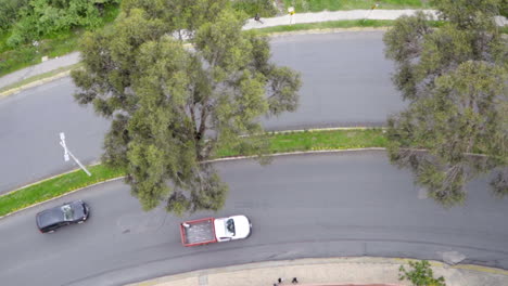 Top-Down-of-Cars-and-Motorcycles-Passing-on-Curved-Road