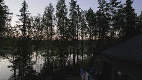 lakeside house and forest at dusk