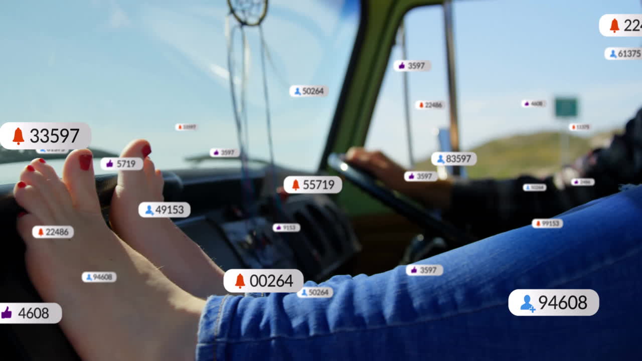 Feet on dashboard with social media notifications animation over road trip scene