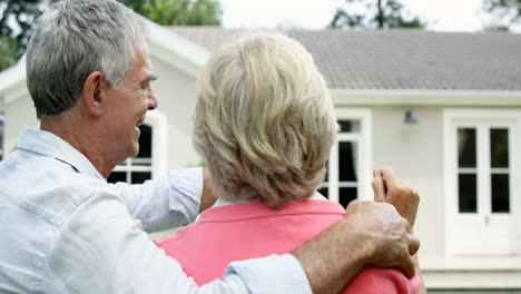 mature couple showing a house