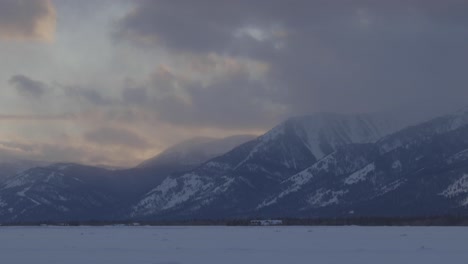 Handheld-shot-of-clouds-rolling-off-of-high-mountain-peaks-at-sunset-in-western-Wyoming