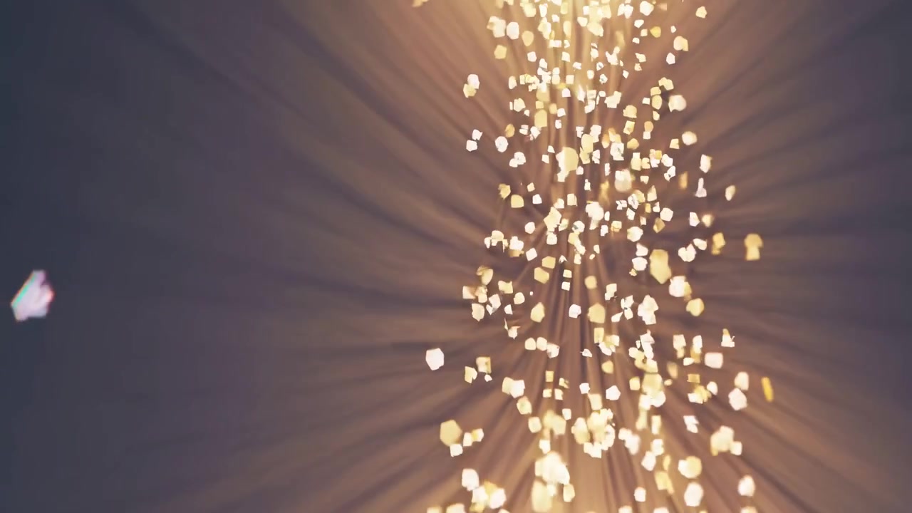 Particelle dorate astratte che fluttuano nei raggi di luce