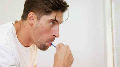 young man brushing his teeth with toothbrush in the bathroom 4k 4k