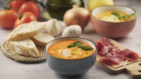 eating salmorejo with bread and serrano ham