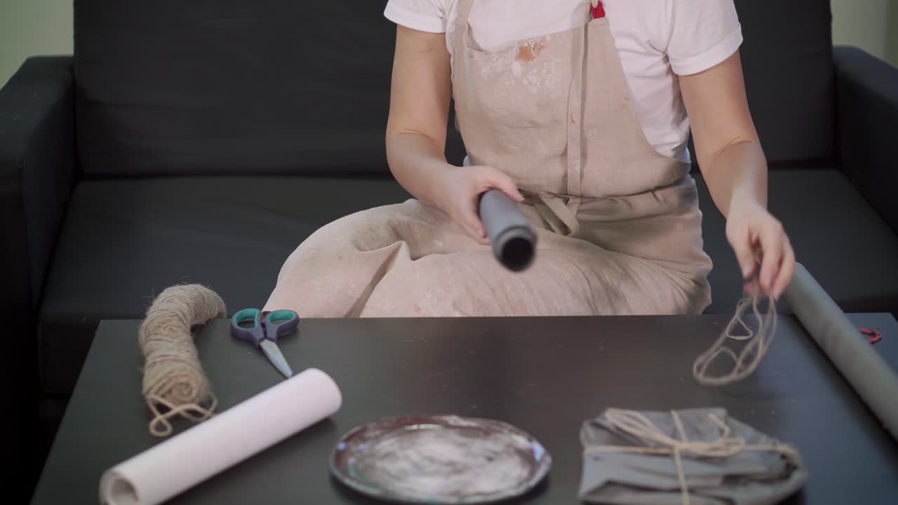 una mujer envolviendo un regalo.