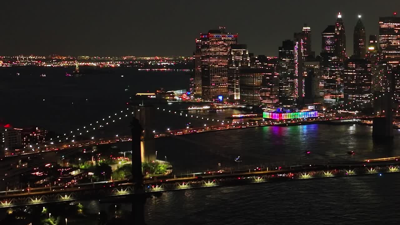 Night view of New York City showcasing vibrant lights and bridges
