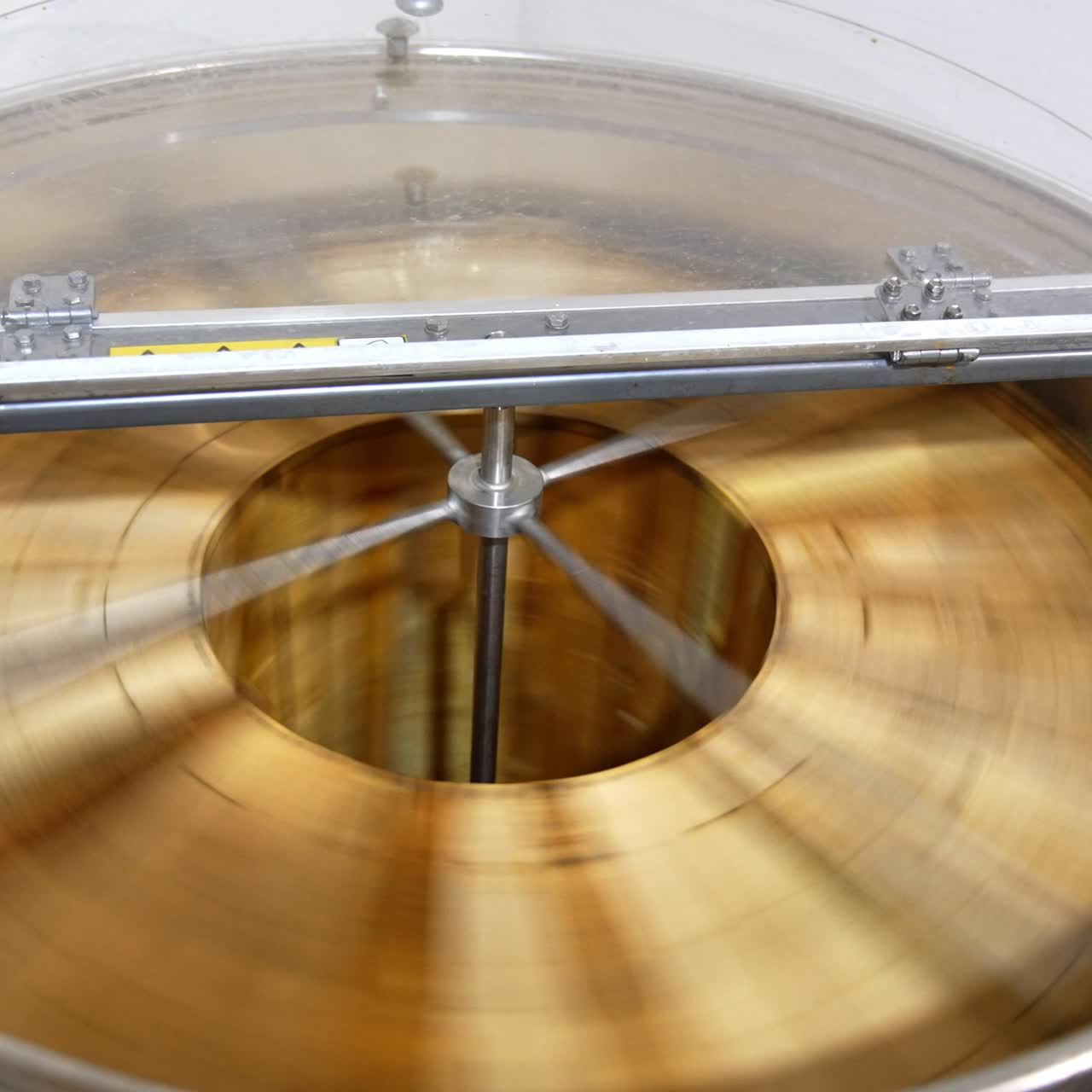 Automatic honey extracting machine rotating many frames at once. Barrel-like apparatus removing honey from honeycombs. Top view