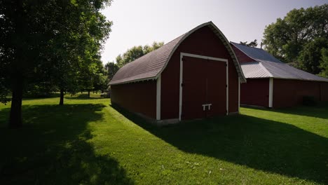 wide-push-in-of-a-red-barn-on-a-farm-on-a-sunny-day