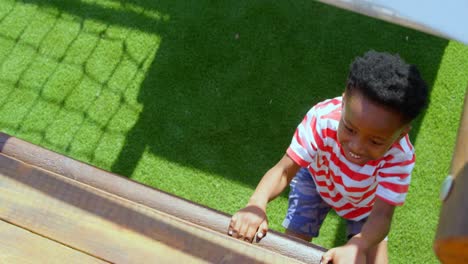 high angle view of african american schoolboy playing in school playground on a sunny day 4k