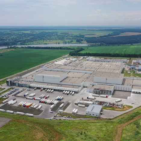 aerial shot of large industrial complex. modern factory background with parking place for trucks on a huge manufacturing territory.
