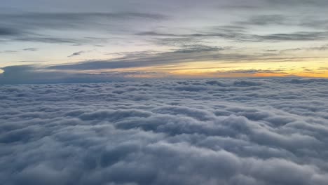 sunrise over the clouds as seen by the pilots while flying over a blanket of clouds
