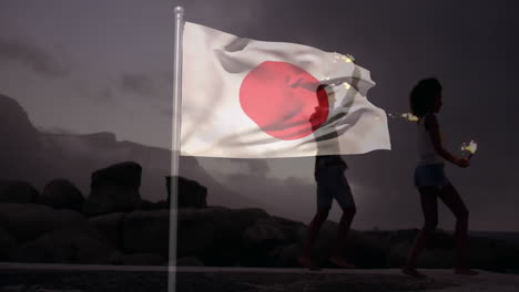 waving japanese flag over silhouette of people walking on rocky landscape animation