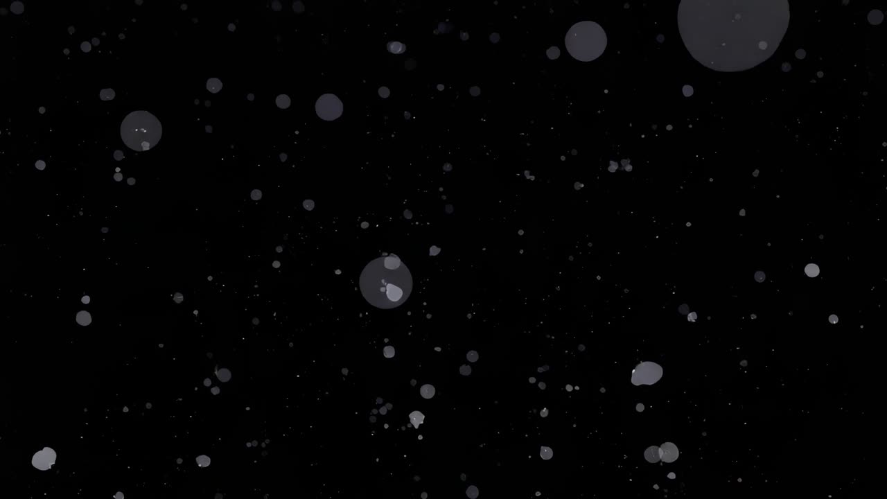 Emerging white specks initiating drifting downward across pitch-black screen, creating depth effect
