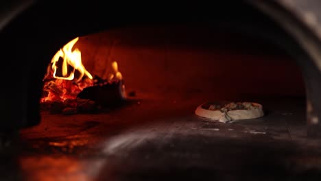 pizza baking in a wood-fired oven