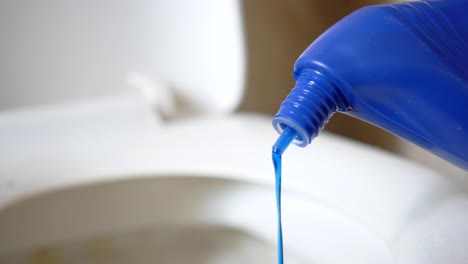 pouring blue toilet bowl cleaner