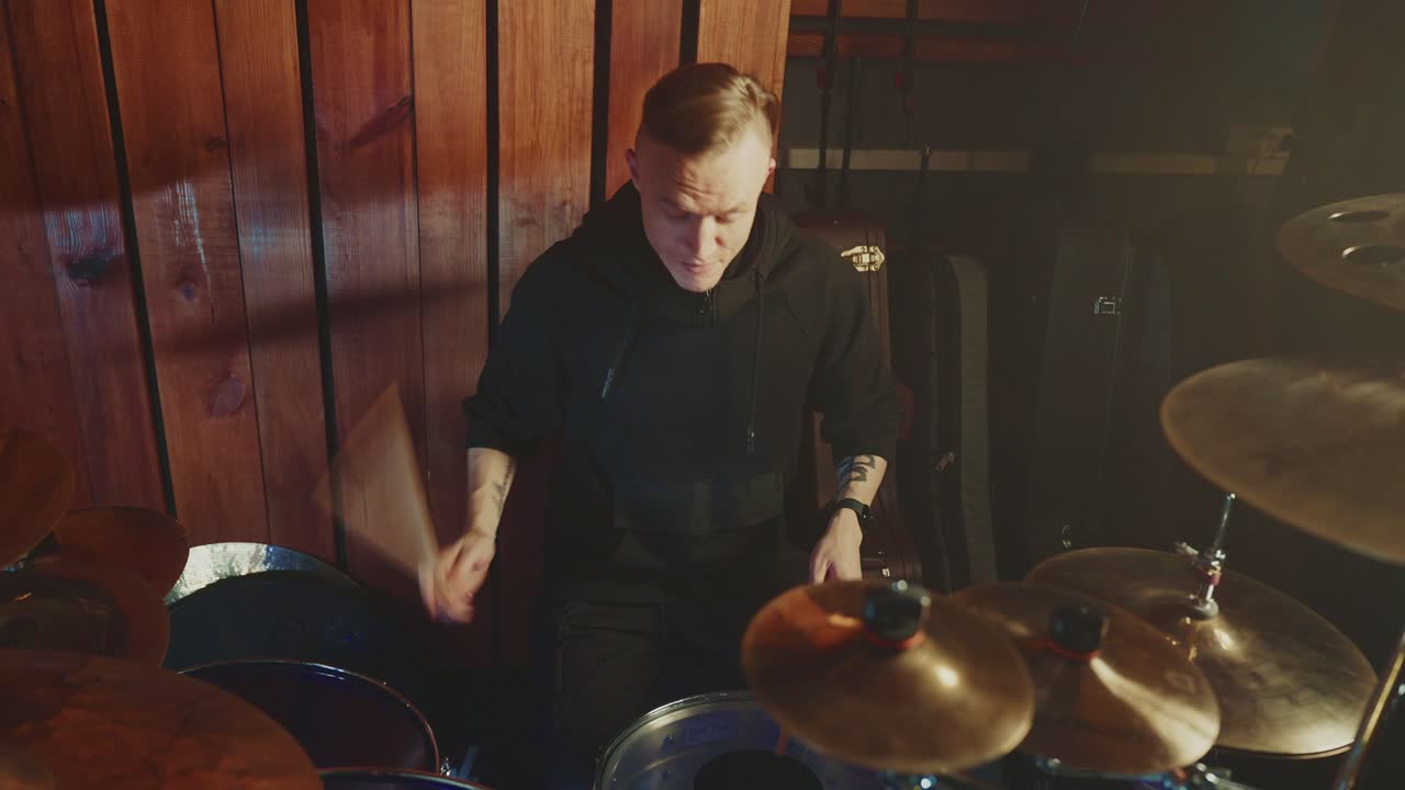 Drummer playing drums in a studio