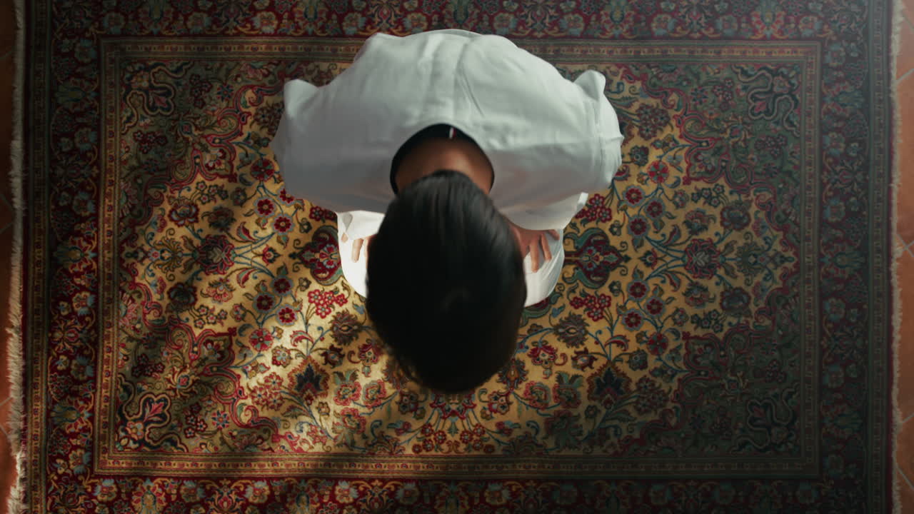 Man Kneeling On Carpet Prays During Ramadan