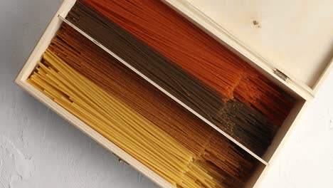 Multicolored-spaghetti-in-wood-box