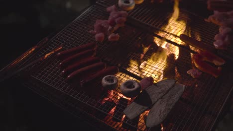 view from top on grilling mushrooms, sausage, chicken, eggplant on bbq in front of the house in a garden