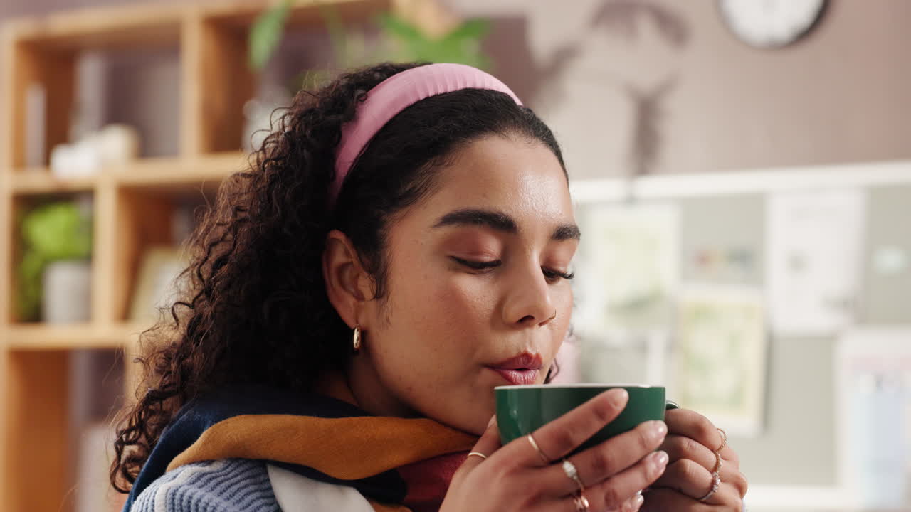 Woman drinking a hot beverage indoors
