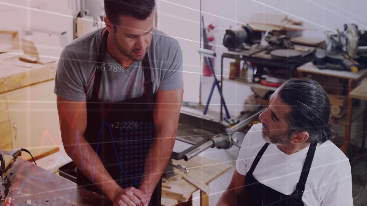 Animation of financial graphs over caucasian men working in carpentry workshop
