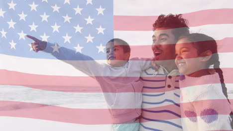 animation of flag of united states of america over biracial father with son and daughter by seaside