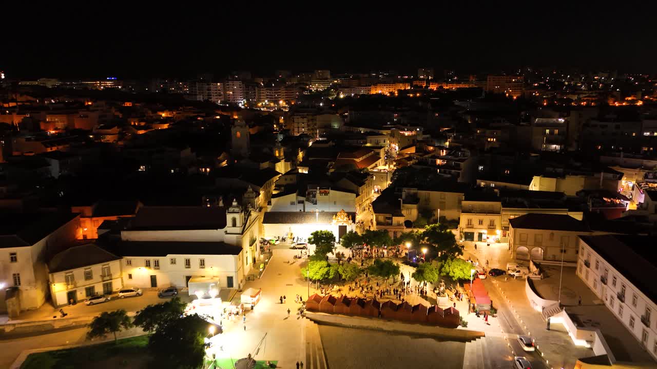Aerial view of Lagos city illuminated at night in Algarve, Portugal
