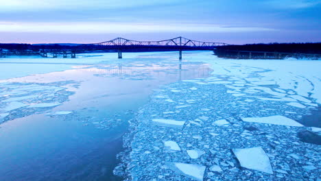 an overhead drone shot capturing the enormity of ice masses drifting in the water