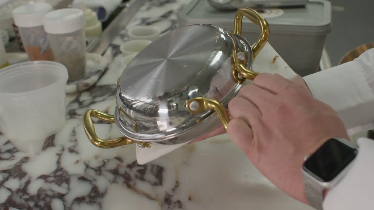 Chef's Hands Opening a Small Pan with Golden Kunefe Dessert