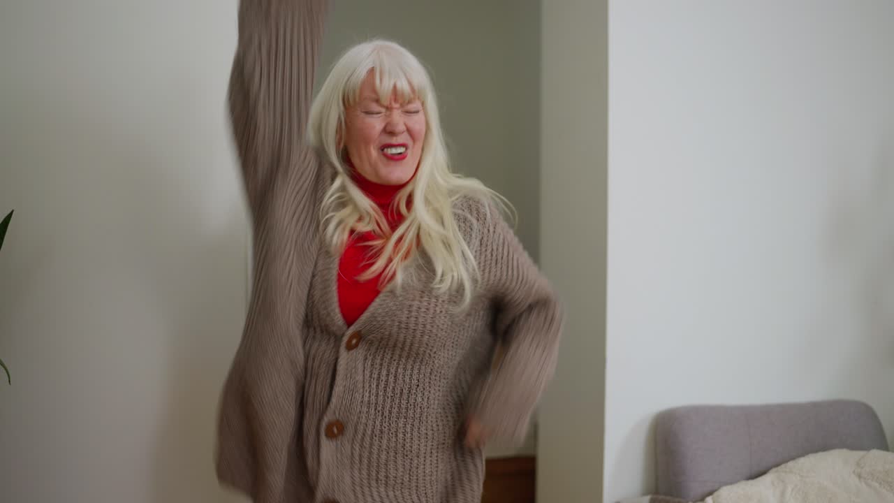 Mature woman dancing indoors