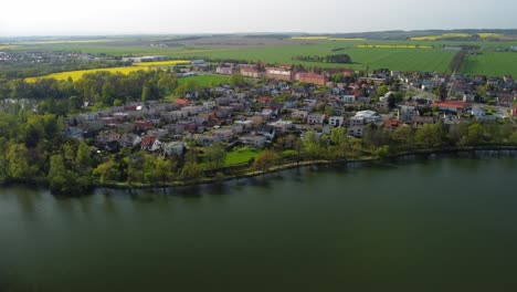 Beautiful-summer-in-the-European-village---green-field-view-on-the-background-of-country-houses