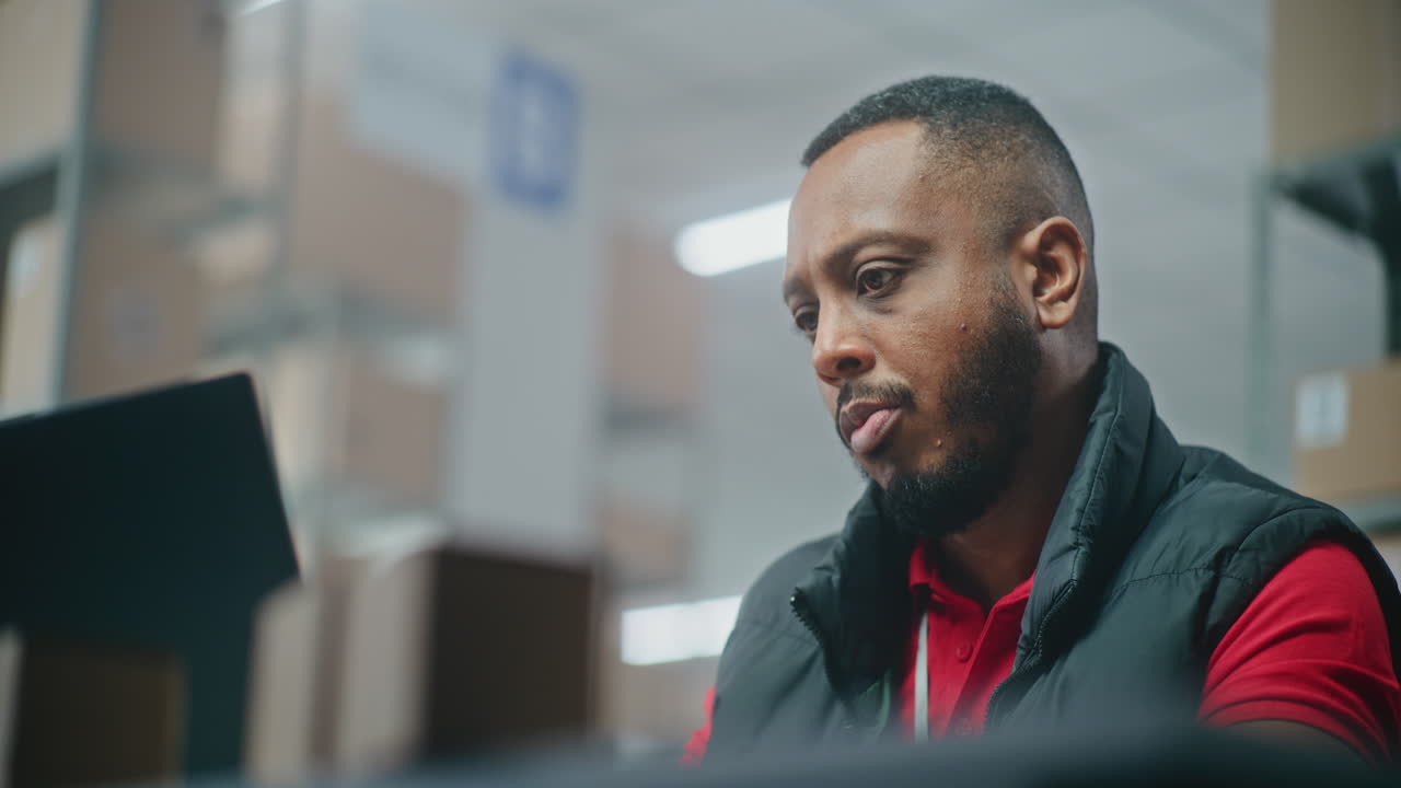 Warehouse Worker Reviewing Data on Tablet