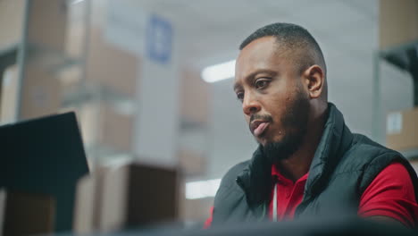 warehouse worker reviewing data on tablet