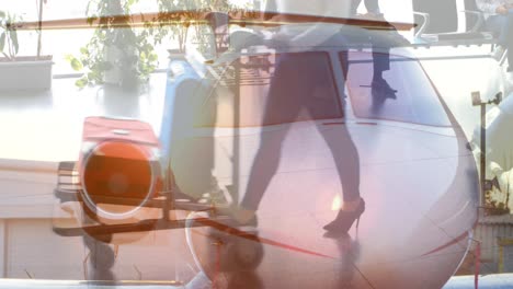 composite video of plane against mid section of people walking at airport