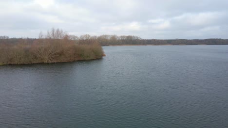 aerial shot zooming in on birds on a lake in winter