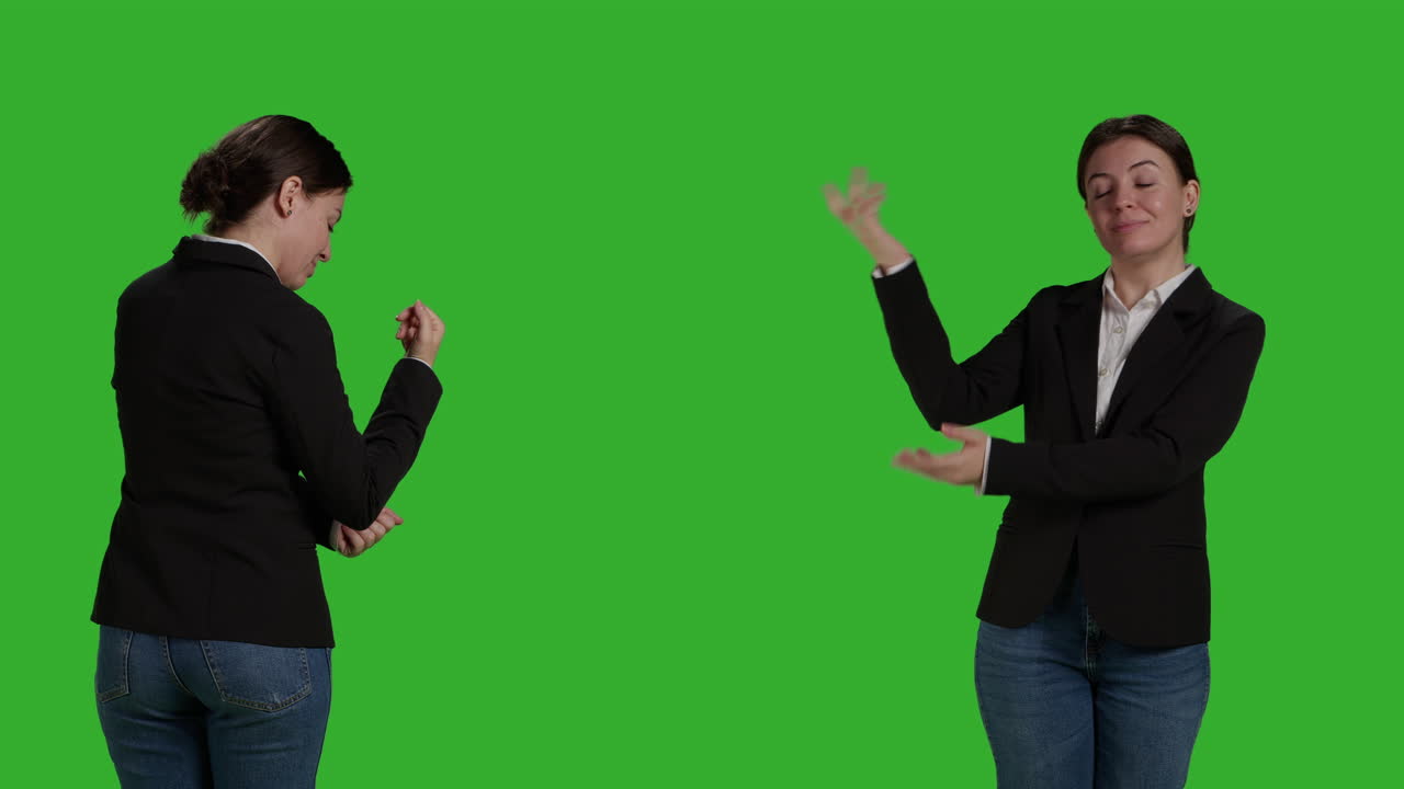 Two women presenting on green screen