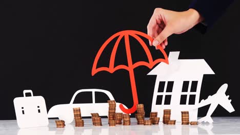 hand of businesswoman holding paper cut out of umbrella