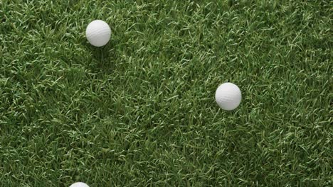 Close-up-of-golf-balls-on-grass,-copy-space,-slow-motion