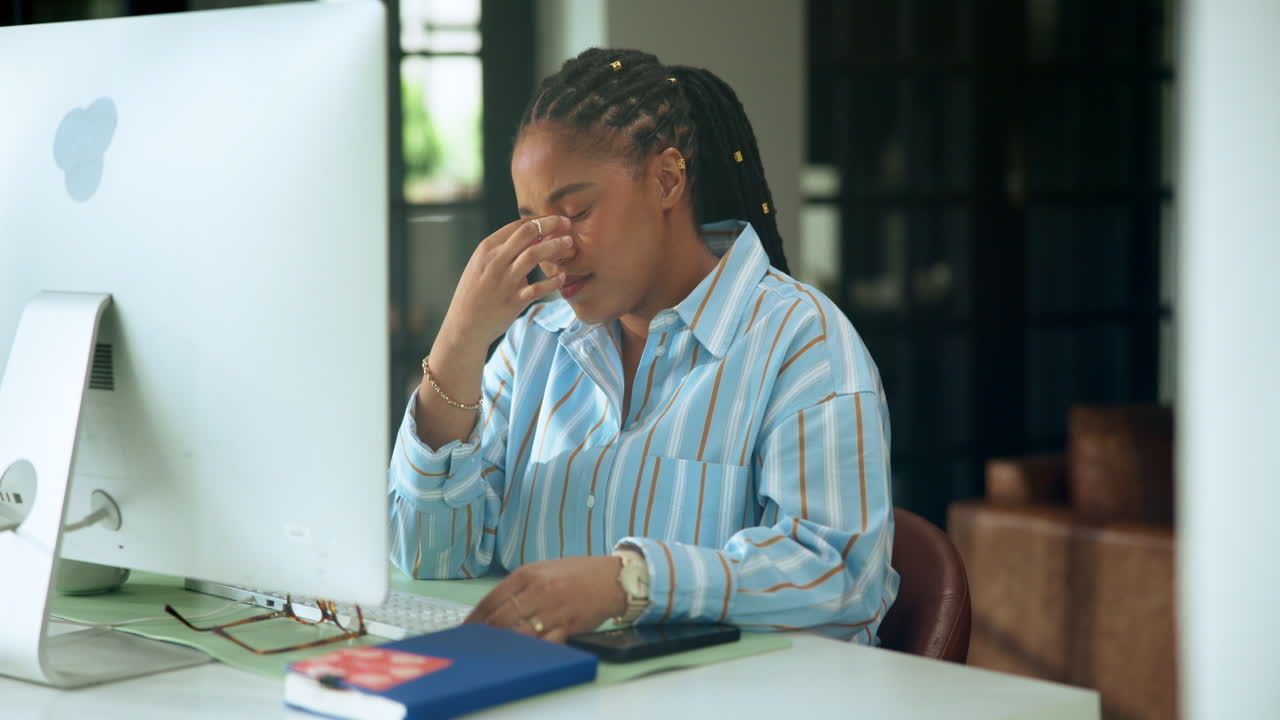 Tired Woman Rubbing Eyes While Working on Computer in Office