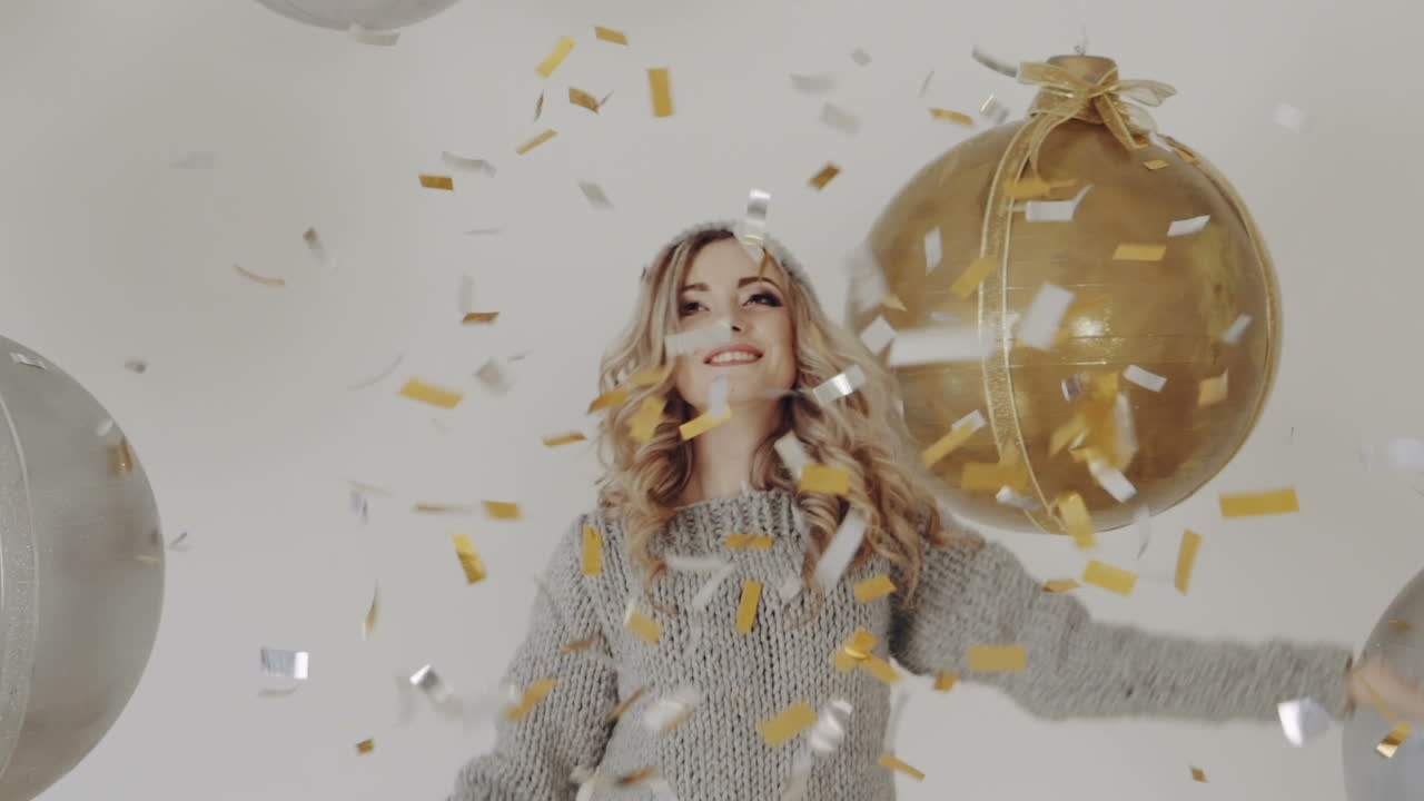 Celebrating new year. Celebration party with confetti falling everywhere on woman