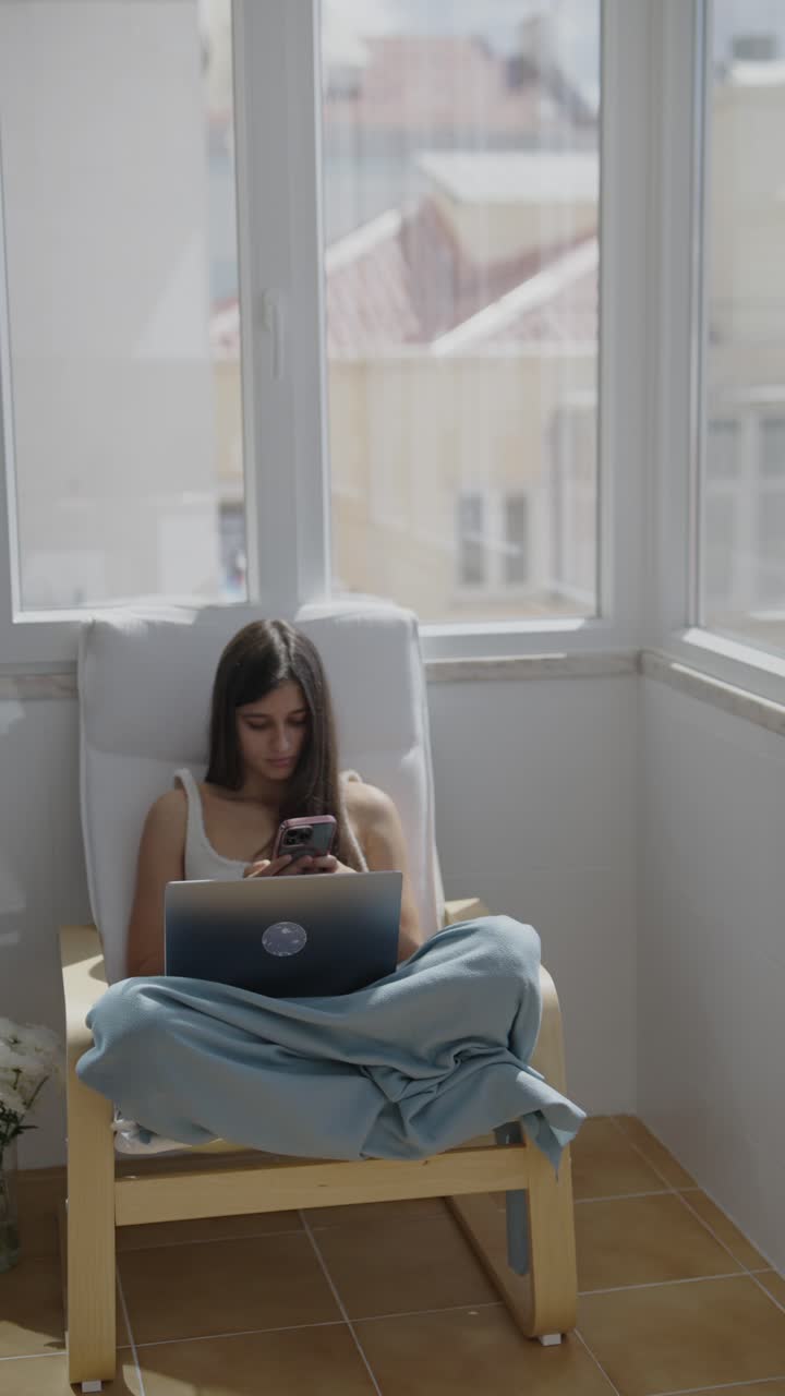 Young Woman Working From Home on Balcony