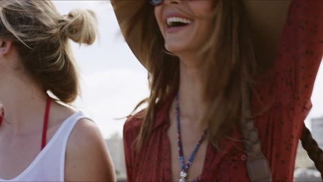 two young girls laughing and walking on beach promenade enjoying carefree vacation