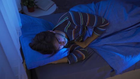 young man sleeping in his bed.