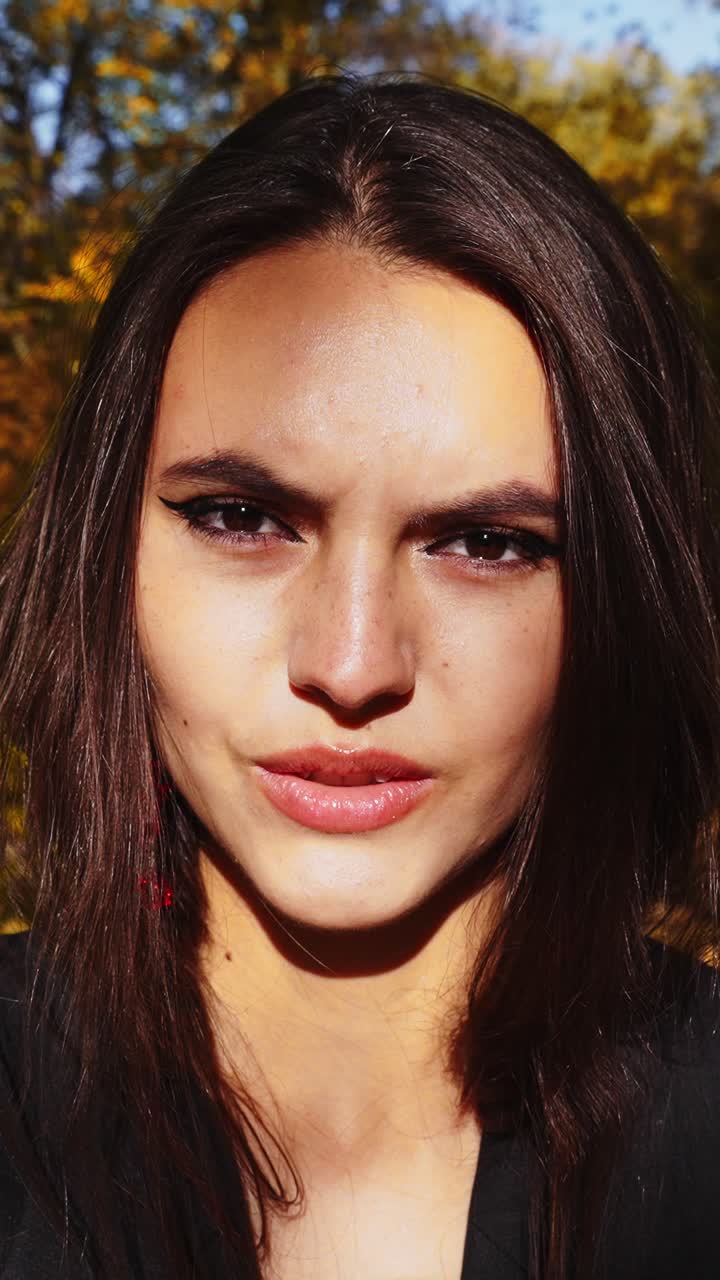 Intense Expression: Capturing the Transformation of Emotions from Calm to Fierce in a Stunning Close-Up Portrait of a Young Woman in Natural Light