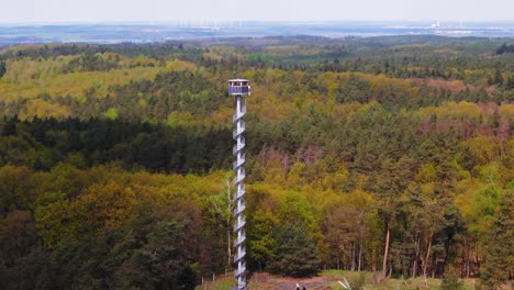 firefighter observation tower between forests, aerial parallax view