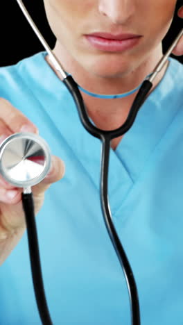 close-up of male surgeon checking with stethoscope