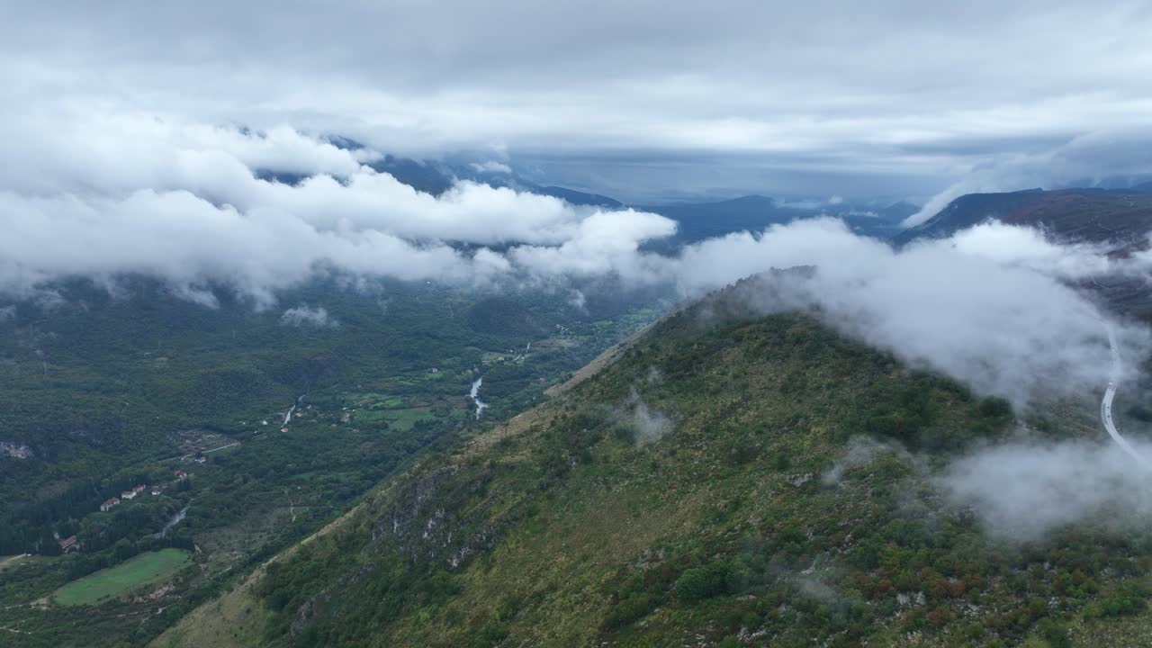 Clouds roll over green mountains near Cetinje, Montenegro on a misty morning
