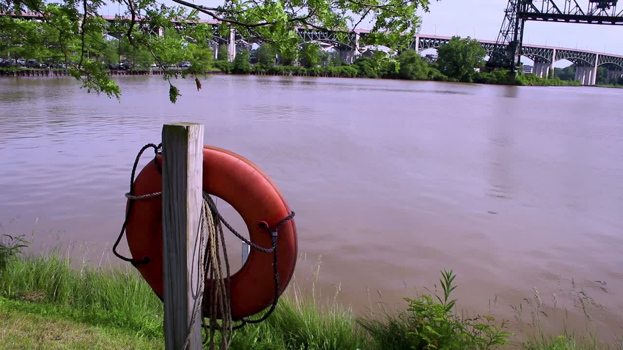 A life raft hangs on a post along the Cuyahoga River